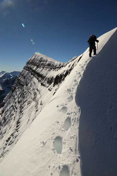 Me ascending the narrow snow arete. Photo by Ben