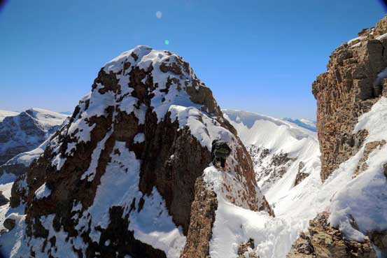 Me carefully climbing up the true summit. Photo by Ben