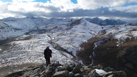 Ben ascending the typical terrain. Behind in the background is a vast alpine meadow