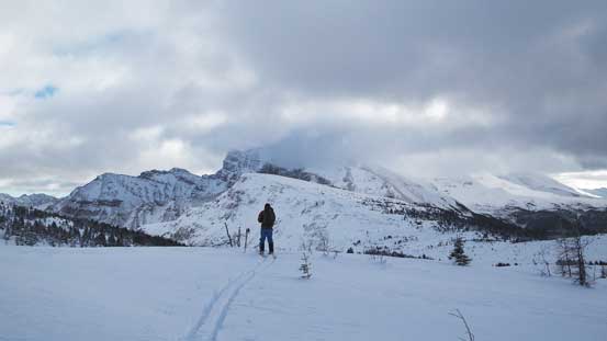 Ben skiing with our objective in front (the lower bump)