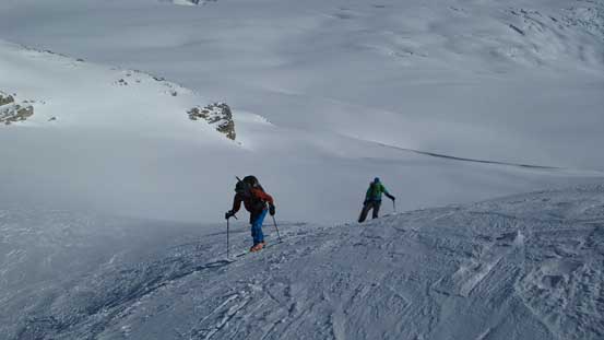 Ben and Vern skinning up a steep and icy slope