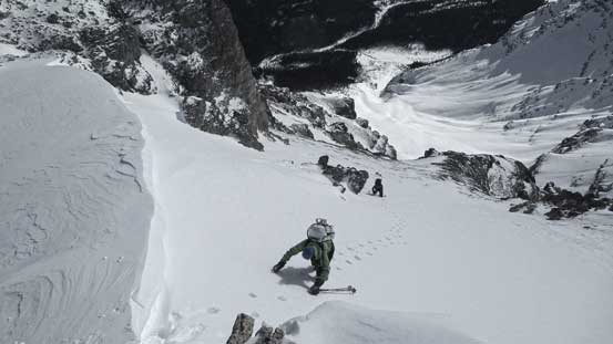Vern following my steps up the final snow climb towards the col. Note the big cornice on left, and the terrain trap (now looks small) way far down in the distance. That's a hack of a slide path!
