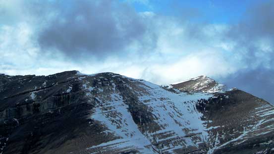 The summit of Evangeline Peak pokes through