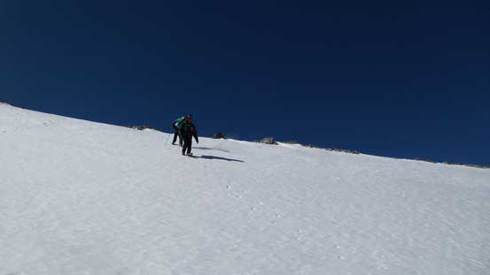 Descending the smaller snow slope near the ridge crest