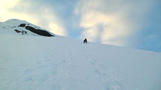 Ben carefully descending the steep face with only 1 crampon