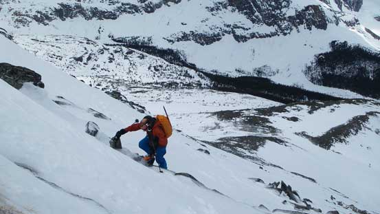 Ben boot-packing down the slope - a mix of boulders and snow