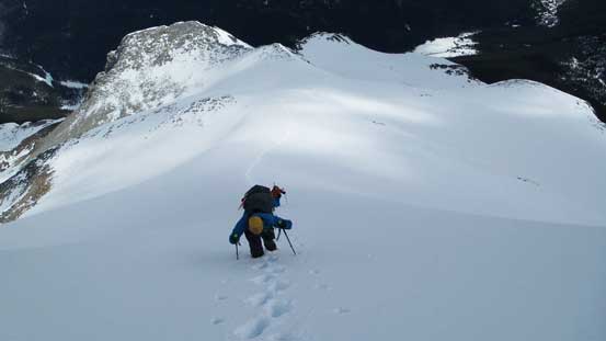 Liam ascending the steep snow