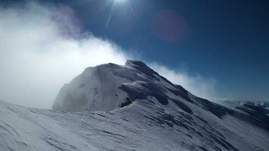 This summit on the climber's right side is a false one, slightly lower