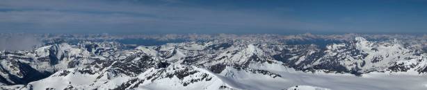 Panorama of a sea of peaks in BC Rockies. In the foreground are Alan Campbell, Arras and Rostrum and Icefall