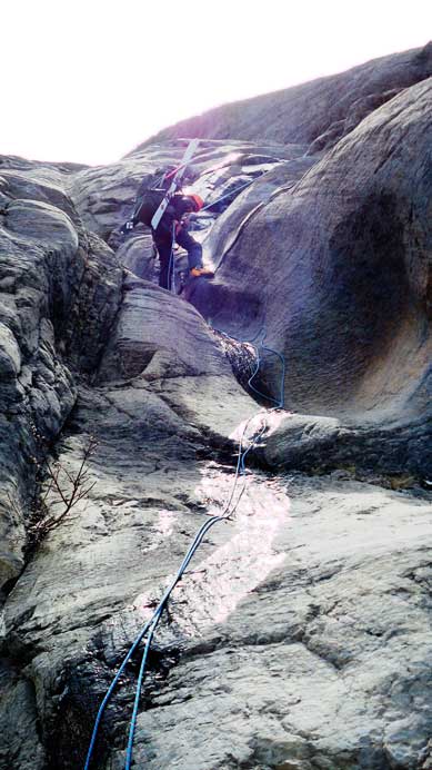 Rappelling the crux. No way to down-climb given the wetness and the ski boots...
