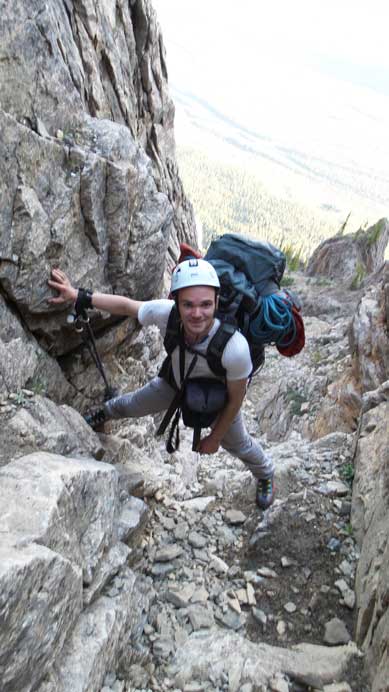 Scrambling up a chimney. An easier option exists just to the climber's right