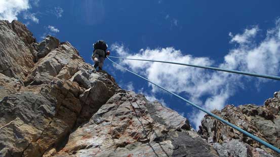 Ben rappelling the upper face