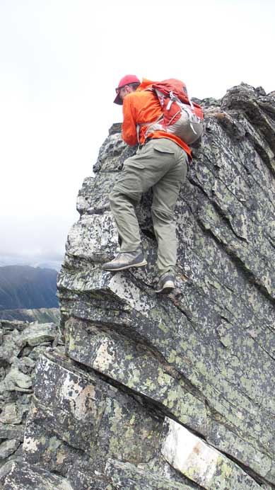 Down-climbing a short, but exposed move along the summit ridge