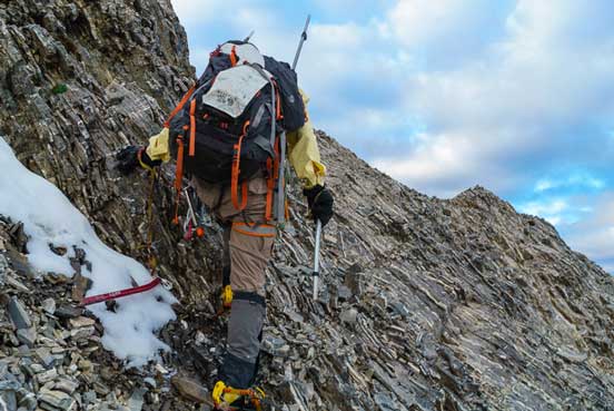 Me ascending the typical (loose) ground to gain the low col. Photo by Vern
