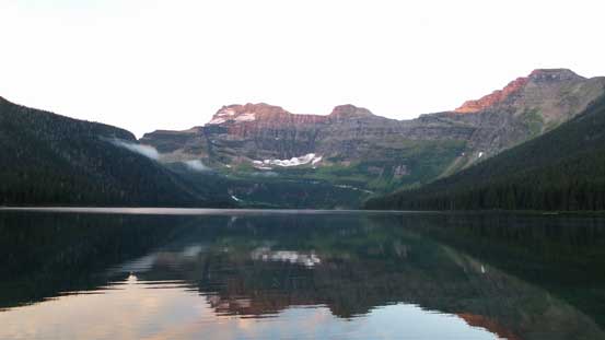 Alpenglow on Mt. Custer and its reflection in Cameron Lake