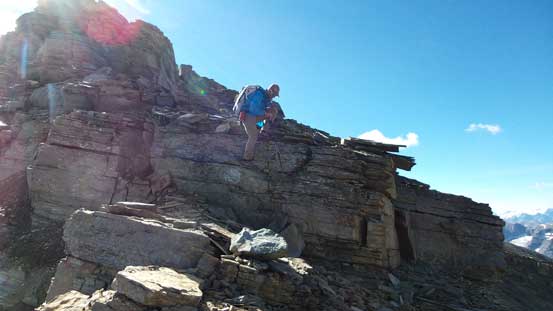 Vern down-climbing a scrambly step on the summit ridge
