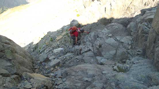 Mike scrambling up the lower cliff bands