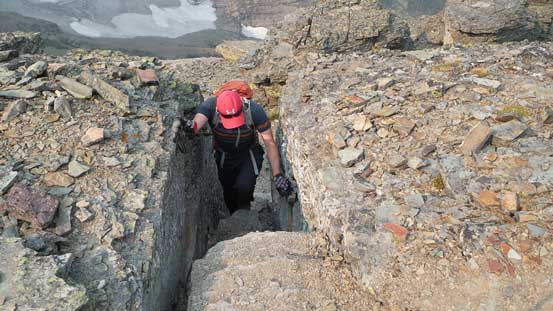 Mike scrambling through a chimney 