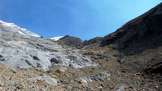 Breaking through the next cliff band on climber's right