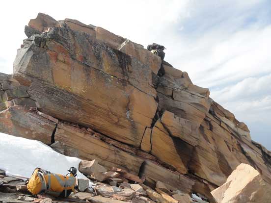 Me starting the crux down-climb. Photo by Maury