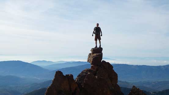 Simon posing on the characteristic pinnacle