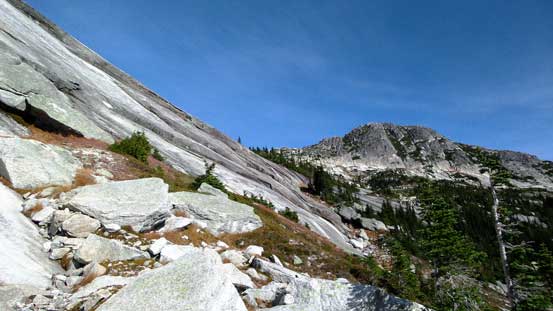 The trail traverses immediately underneath these slabs