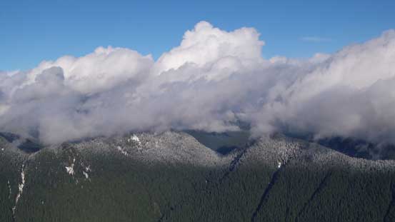 Clouds hovering above the forested bumps - Wizard Peak and Magic Peak