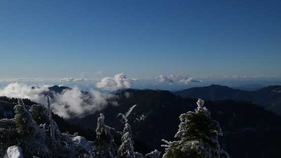Another view of some low clouds and some forested peaks