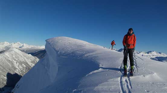 Traversing beside the huge summit cornice