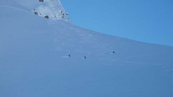 Looking back at Alex, Ben and Alan skiing down the glacier