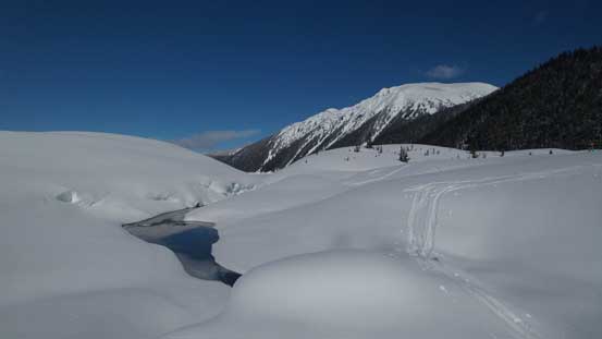 Crossing a creek on a solid snow bridge
