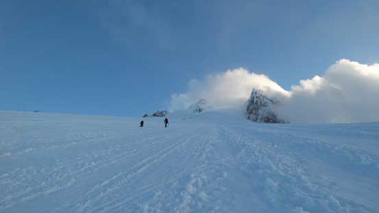 The typical plodding. Note the wind blowing the clouds engulfing the summit