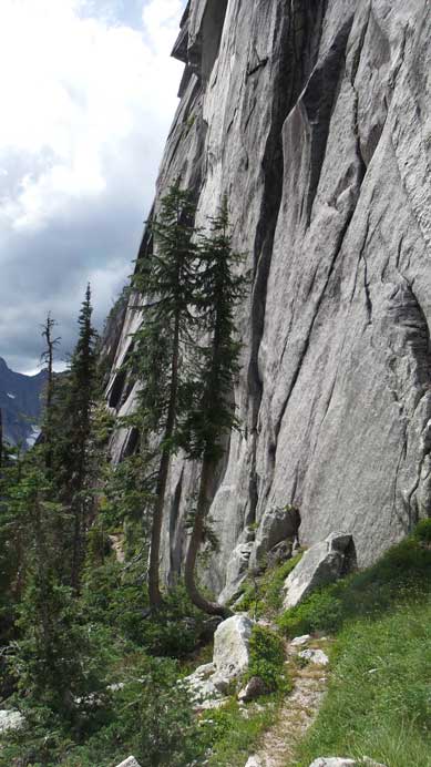 The trail descends parallel this steep wall