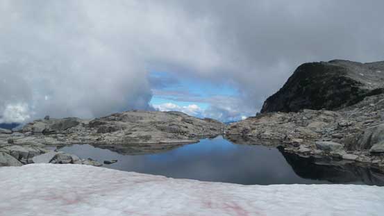 A neat tarn fed by a snowfield