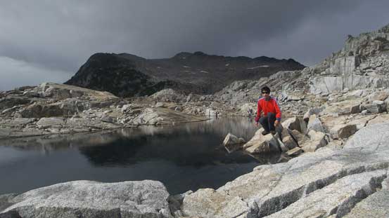 Me posing at the tarn. Note the weather - another set of clouds were moving in rapidly...