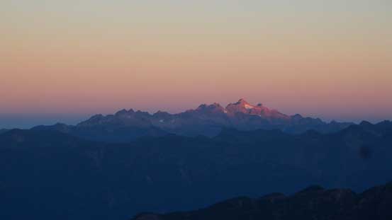 The tip of Twin Sisters Range just started to glow