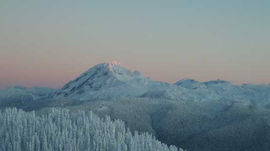 The tip of Atwell Peak catches the glow