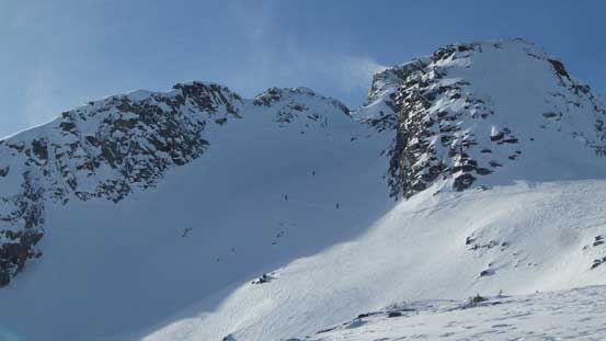 The lower group of skiers ascending the "south side bowl"